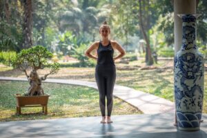 Qigong exercises for back pain. A woman practicing qigong in a park